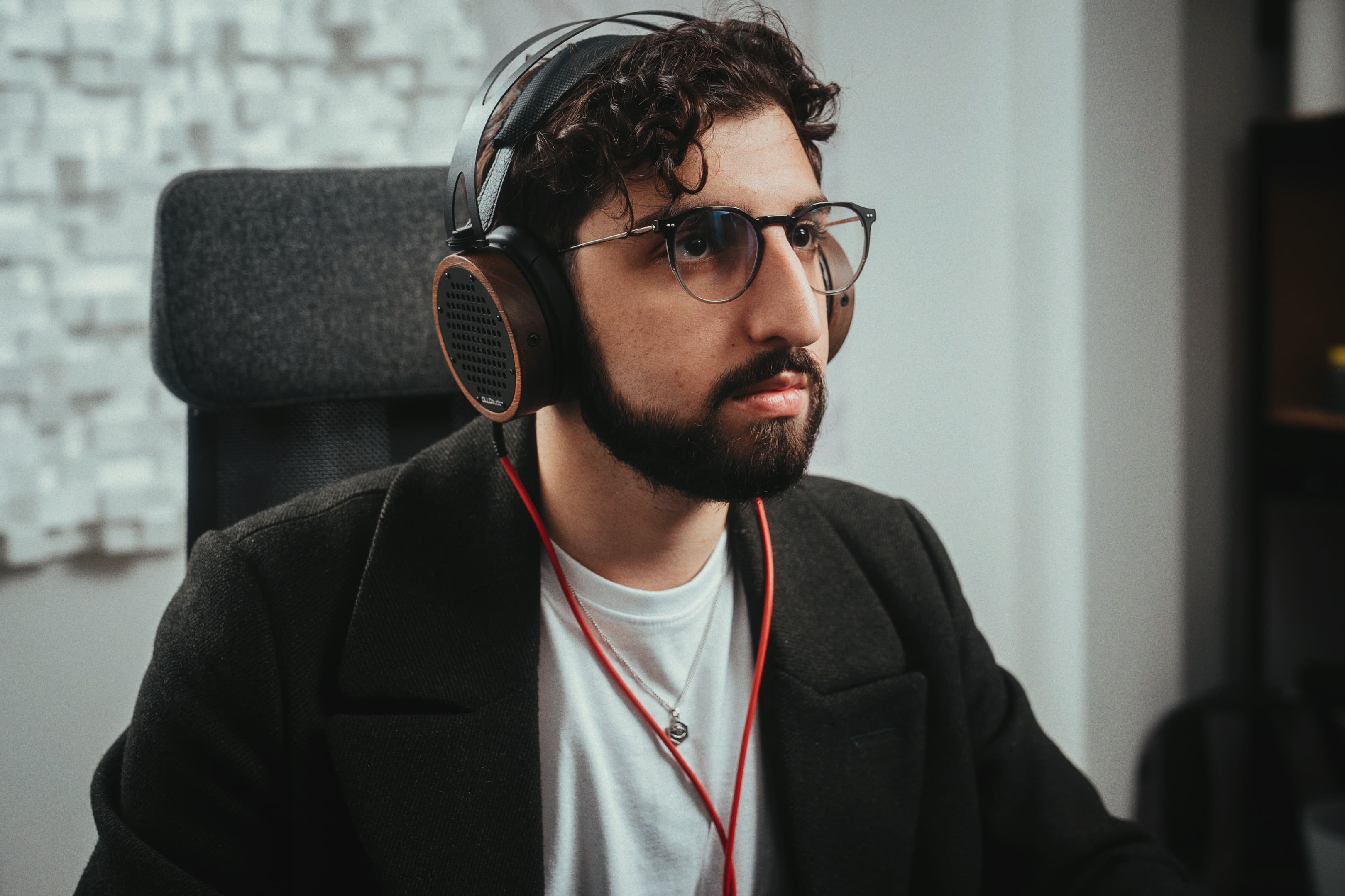 Daniel Nesci listening through headphones in his studio
